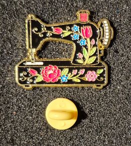 Sewing machine, pin back badge.