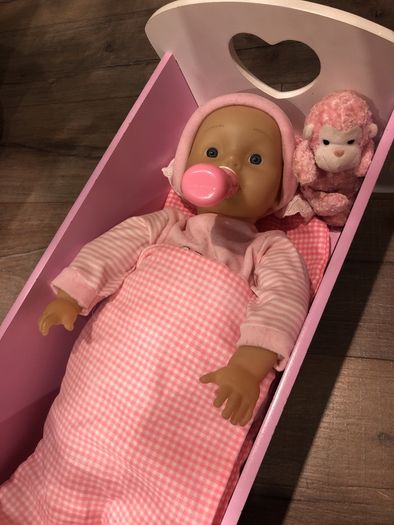 Doll crib with a baby