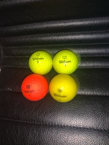 (4) Wilson colored golf balls