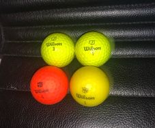 (4) Wilson colored golf balls