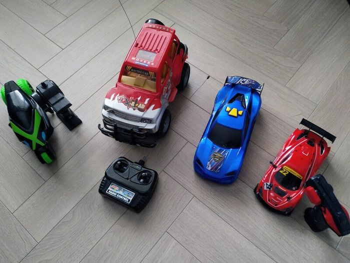 3 remote control vehicles & 1 blue racecar with lights & sounds