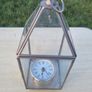 Table clock in a glass lantern. Image 7