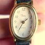 Vintage Timex womens quartz watch - gold tone oval case, white dial and black strap Image 8