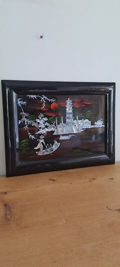 Vintage Vietnamese black lacquer wall plaque featuring intricate mother-of-pearl inlay.