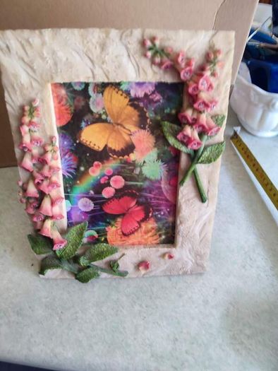 BUTTERFLIES picture framed in stone finish frame edged with flowers.