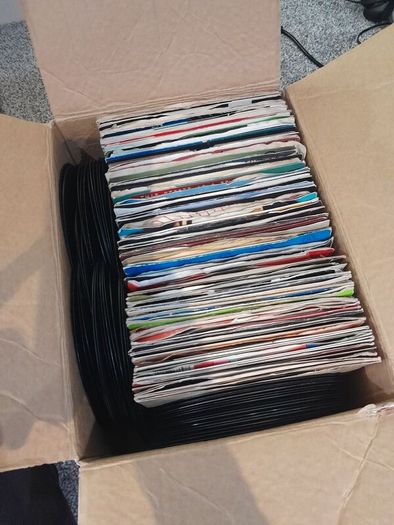 a box of 7" singles. 45 rpm vinyl records.