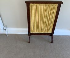 A restored Edwardian oak fire screen, 76 centimetres high, 52 centimetres wide