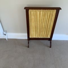 A restored Edwardian oak fire screen, 76 centimetres high, 52 centimetres wide