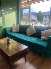 Emerald green velvet sofa