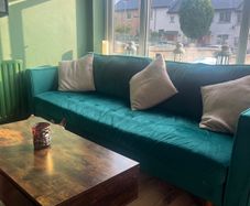 Emerald green velvet sofa