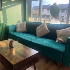 Emerald green velvet sofa