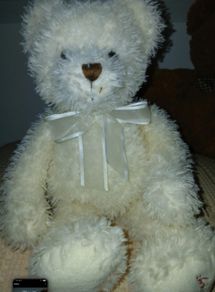 White hamleys teddy bear baby gift.  Soft white teddy with white bow.