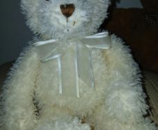 White hamleys teddy bear baby gift.  Soft white teddy with white bow.