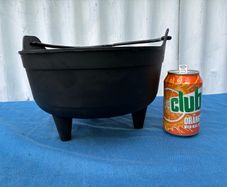 Black plastic flower pot on raiserd legs
