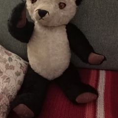 Antique straw-filled panda teddy bear