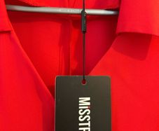 Brand new dress . Still with tag but with stained on left sleeve.