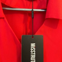 Brand new dress . Still with tag but with stained on left sleeve.