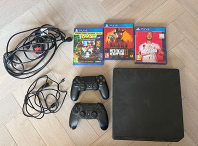 Sony PlayStation 4 console with two controllers and three games