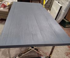 Grey dining table with chrome X legs