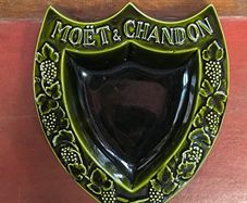 vintage Moet & Chandon shield-shaped ceramic advertising piece.