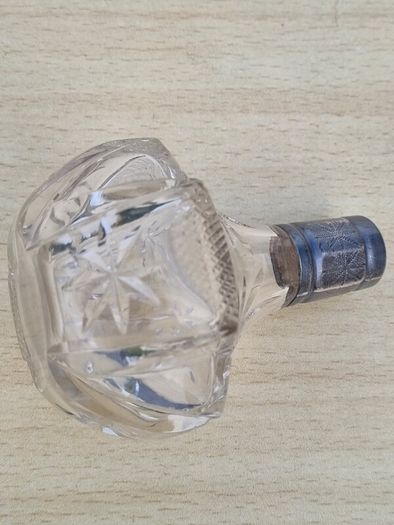 Vintage crystal bottle with silver top