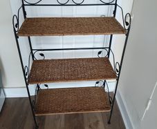 antique shelf unit metal and weave . Shelves clip out and frame folds for easy transport