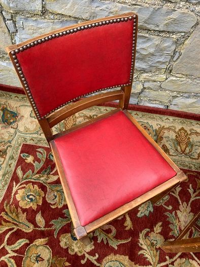 A pair of mid century leatherette kitchen chairs.