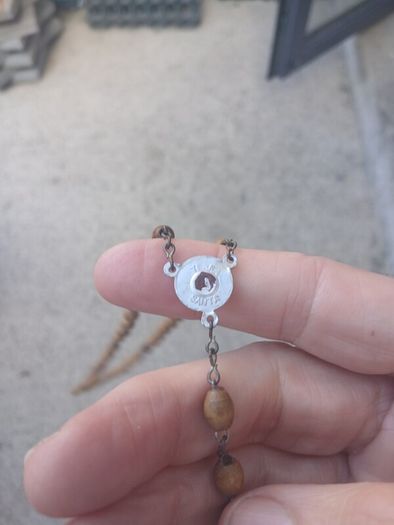 Title: Authentic Jerusalem Olive Wood Rosary & Leather Case  Description: Selling an authentic Catholic rosary made from Holy Land olive wood beads. The back of the crucifix is stamped "JERUSALEM", and the center medal is stamped "TERRA SANTA" with a 