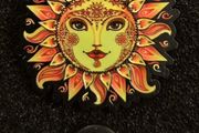 Sun,   pin back badge.