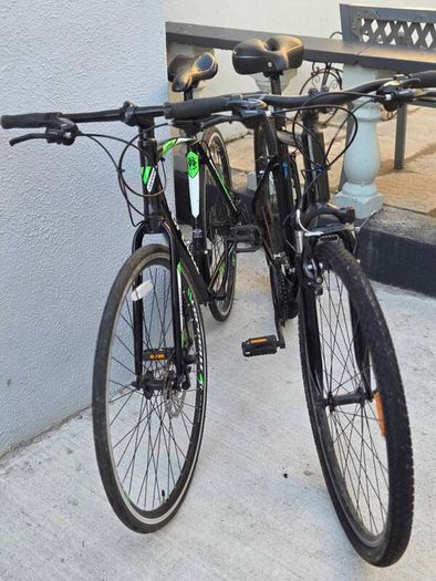 Two bikes one mountain one is a type of racing mountain bike
