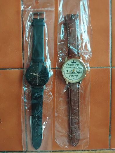 2 mens watches with leather straps.