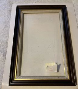 frame A rich dark-wood and gilt picture frame featuring a textured fabric mat liner.