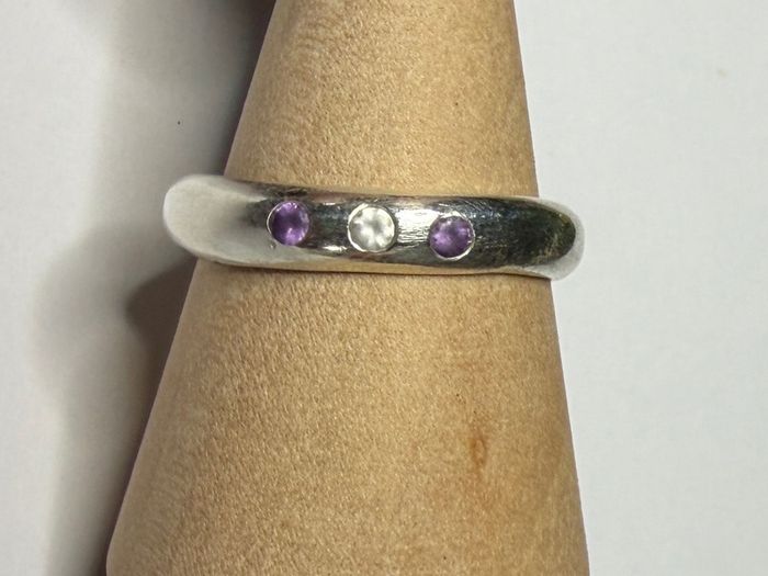 Handmade sterling silver ring with flush set stones. Size O
