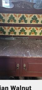 victorian washstand with marble top and art nouveau tiles.