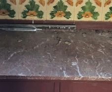 victorian washstand with marble top and art nouveau tiles.