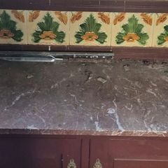 victorian washstand with marble top and art nouveau tiles.