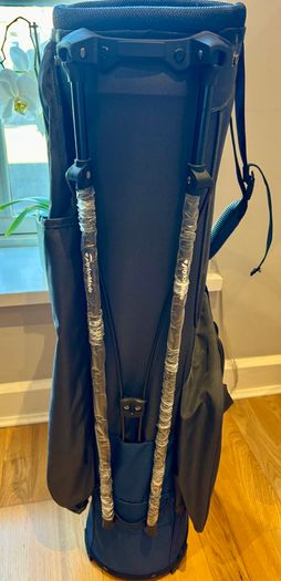 NEW - TaylorMade FlexTech Stand Bag (Black/Blue), stand legs still have the factory wrapping on them.