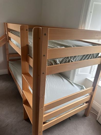 Bunk bed with attached slide and mattresses