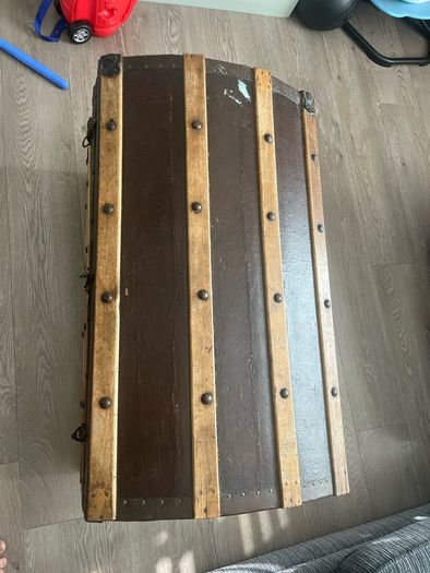 Old travellers chest , lined with super heroes and used as toy chest