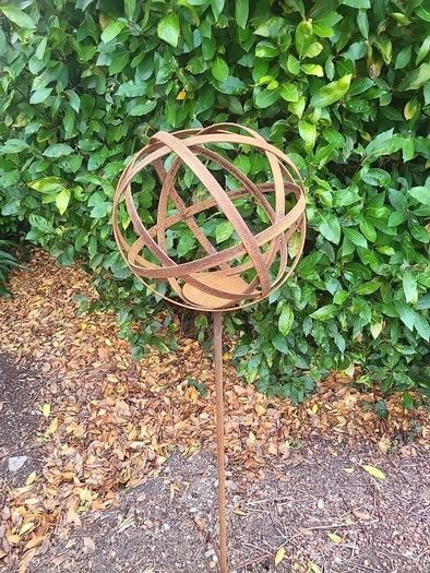 Corten steel garden sphere on a stem