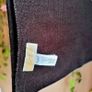 Authentic Michael Kors reversible knit scarf in charcoal black/heather grey with oversized MK logo detail. Image 6