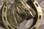 two brass horse shoe door knockers