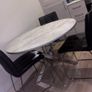 Round marble-effect dining table with 4 black chairs Image 5