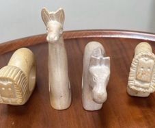 Four sandstone animal serviette holders or ornaments
