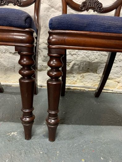A pair of Victorian mahogany balloon back chairs with tapestry seats.