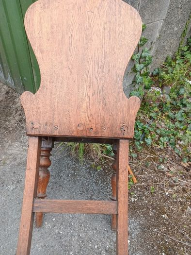 two oak chairs and an old  card table