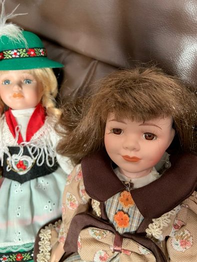 5 porcelain dolls with extra clothing perfect condition
