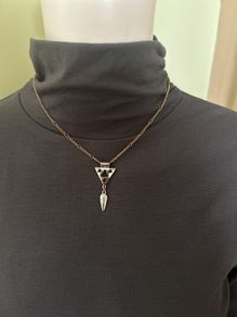 Gold tone necklace with silver tone geometric pendant