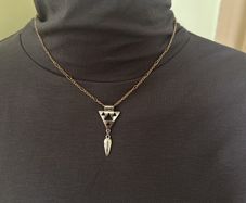 Gold tone necklace with silver tone geometric pendant
