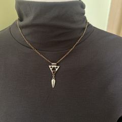Gold tone necklace with silver tone geometric pendant
